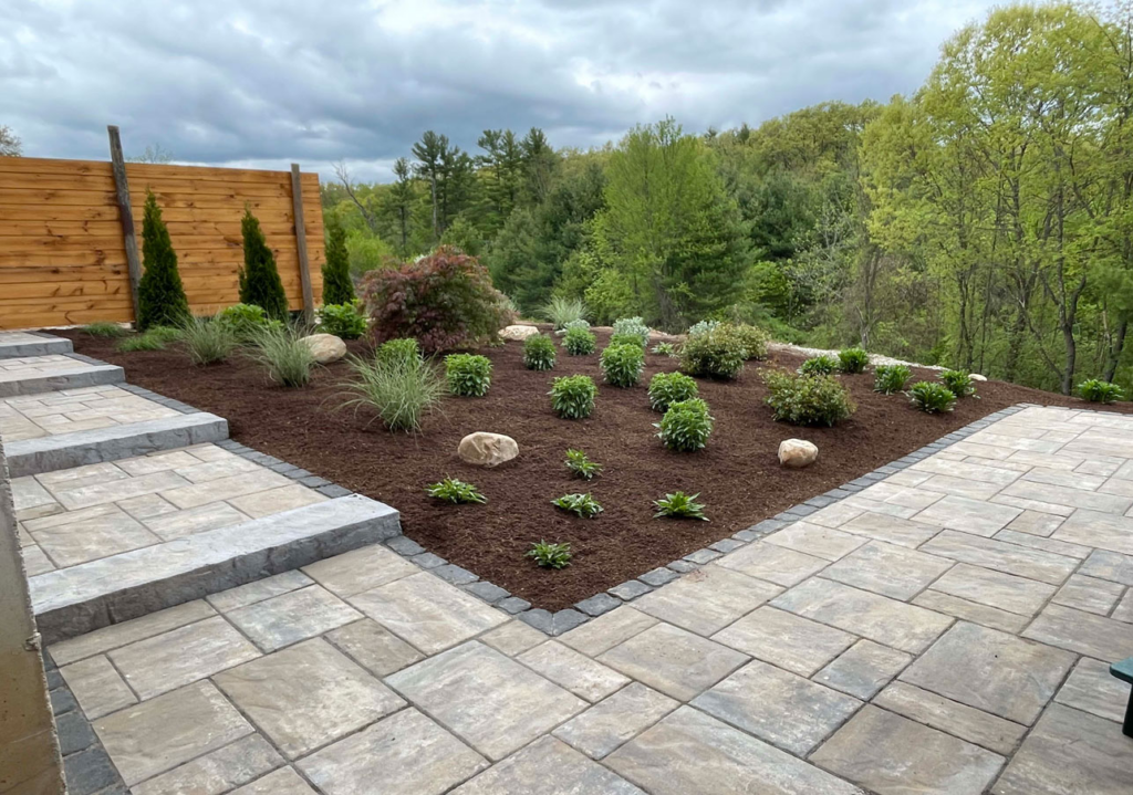Completed hardscape and planting installation by Tynic Landscaping near Springfield, MA.