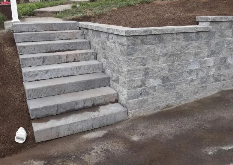 Gray block retaining wall with stone steps