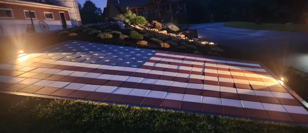 Paver patio laid as an American flag, lit at night