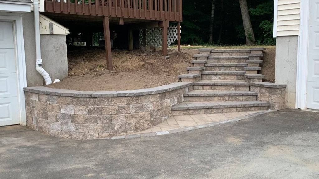 Rebuilt retaining wall with stone steps
